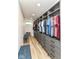 Spacious closet with custom shelves, drawers, modern design, hardwood floors, and bench seating at 1620 W New York St, Indianapolis, IN 46222