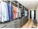 Walk-in closet featuring custom shelves, multiple drawers, hanging racks, and bench seating at 1620 W New York St, Indianapolis, IN 46222