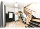View of foyer featuring hardwood floors, a stylish staircase, and a glimpse into the dining area at 1620 W New York St, Indianapolis, IN 46222
