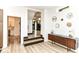 Hallway with stylish console table and hardwood floors at 1620 W New York St, Indianapolis, IN 46222