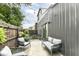 Enclosed patio with comfortable seating, string lights, modern building, and decorative plants at 1620 W New York St, Indianapolis, IN 46222