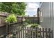 Fenced backyard featuring a garden, potted plants, gravel pathway, and garden bed at 1620 W New York St, Indianapolis, IN 46222