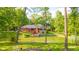 Beautiful backyard featuring a pond and outdoor space with a wood-burning fire pit, surrounded by lush landscaping at 1633 W 200 North, Greenfield, IN 46140