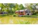 The backyard has a beautiful pond and house with solar panels; lush landscaping provides great scenery at 1633 W 200 North, Greenfield, IN 46140