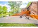 A backyard area that has a firepit, seating area, wooden deck, and lush green landscaping at 1633 W 200 North, Greenfield, IN 46140