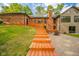 A house featuring a wooden staircase leading down to the back yard with an outdoor fire pit and deck at 1633 W 200 North, Greenfield, IN 46140