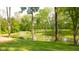 Picturesque backyard pond with grassy bank and surrounding trees at 1633 W 200 North, Greenfield, IN 46140