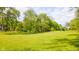Spacious backyard with mature trees providing ample shade and privacy at 1633 W 200 North, Greenfield, IN 46140
