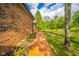 Charming backyard with wooden pathway, lush lawn, and serene pond views at 1633 W 200 North, Greenfield, IN 46140