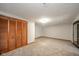 Unfurnished basement with neutral carpet, a sliding glass door, and closet with wooden doors at 1633 W 200 North, Greenfield, IN 46140
