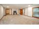 Expansive finished basement with neutral carpet, modern paint, and multiple access doors at 1633 W 200 North, Greenfield, IN 46140