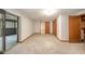 Spacious basement with neutral carpet, a sliding glass door, and doors leading to other rooms at 1633 W 200 North, Greenfield, IN 46140