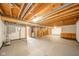Exposed basement awaiting finishing with wood beams, utility access, and a single cabinet at 1633 W 200 North, Greenfield, IN 46140