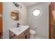 Contemporary bathroom with modern vanity, toilet, and round mirror at 1633 W 200 North, Greenfield, IN 46140