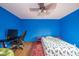 Bedroom with hardwood floors, ceiling fan, and bright blue painted walls at 1633 W 200 North, Greenfield, IN 46140