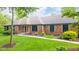 Charming one-story brick home with manicured lawn and lush landscaping at 1633 W 200 North, Greenfield, IN 46140