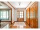 Inviting foyer with wood flooring, trim, a front door with sidelights, a sliding door closet and natural light at 1633 W 200 North, Greenfield, IN 46140