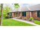 Well-manicured lawn and mature landscaping enhance this brick home, complete with stone accents and a welcoming front entrance at 1633 W 200 North, Greenfield, IN 46140