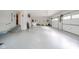 Organized garage featuring epoxy flooring, interior access, and overhead garage doors at 1633 W 200 North, Greenfield, IN 46140