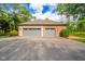 Detached two-car garage featuring stone and brick construction, gray doors, and updated lighting at 1633 W 200 North, Greenfield, IN 46140