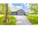 Modern outbuilding with a metal roof and multiple garage doors, set on a gravel driveway at 1633 W 200 North, Greenfield, IN 46140