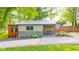 Charming outbuilding featuring a covered porch with seating and a lovely garden area at 1633 W 200 North, Greenfield, IN 46140