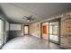 Bright sunroom with brick walls, tiled floors, and access to the outside through sliding doors at 1633 W 200 North, Greenfield, IN 46140
