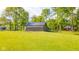 Expansive yard with lush greenery and a well-maintained outbuilding in a serene setting at 1633 W 200 North, Greenfield, IN 46140