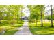 Beautiful yard with mature trees, a gravel driveway, and a glimpse of the outbuilding at 1633 W 200 North, Greenfield, IN 46140