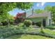 Backyard with lush landscaping features mature trees and shrubs with a well maintained lawn at 1748 Sweet Gum Dr, Indianapolis, IN 46260