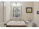 Well-lit bathroom features a vanity with granite countertop, updated fixtures and a neutral color palette at 1748 Sweet Gum Dr, Indianapolis, IN 46260