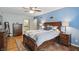 Inviting bedroom with hardwood floors, neutral walls, ensuite bathroom, and ample natural light at 1748 Sweet Gum Dr, Indianapolis, IN 46260