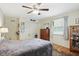 Bedroom featuring hardwood floors, ceiling fan, closet, and bed with comfortable bedding at 1748 Sweet Gum Dr, Indianapolis, IN 46260