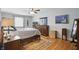 Cozy bedroom with hardwood floors, ceiling fan, ample natural light, and generous closet space at 1748 Sweet Gum Dr, Indianapolis, IN 46260