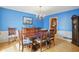Dining room featuring vibrant blue walls and a chandelier above a wooden dining table at 1748 Sweet Gum Dr, Indianapolis, IN 46260