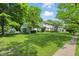 Charming two-story home with an attached garage, lush green lawn, and mature trees at 1748 Sweet Gum Dr, Indianapolis, IN 46260