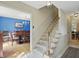 Foyer featuring a staircase, tiled floor, and views into the dining room at 1748 Sweet Gum Dr, Indianapolis, IN 46260