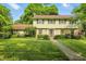 Charming two-story home featuring a stone facade and a well-manicured lawn at 1748 Sweet Gum Dr, Indianapolis, IN 46260