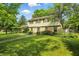 Traditional home with a spacious green lawn, complemented by lush trees and landscaping at 1748 Sweet Gum Dr, Indianapolis, IN 46260