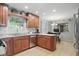 This open kitchen features stainless appliances, wood cabinets, and granite countertops at 1748 Sweet Gum Dr, Indianapolis, IN 46260