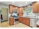Updated kitchen features stainless steel appliances, wood cabinets and eat-in area at 1748 Sweet Gum Dr, Indianapolis, IN 46260
