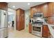Modern kitchen features stainless steel appliances, hardwood floors, and wood cabinets at 1748 Sweet Gum Dr, Indianapolis, IN 46260