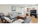 Comfortable living room features hardwood floors, plush seating, and an open view to the kitchen at 1748 Sweet Gum Dr, Indianapolis, IN 46260