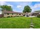 Large backyard with lush lawn, stepping stones, mature trees, a patio, and an additional outbuilding at 1891 W 300 N, Anderson, IN 46011