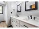 Bright bathroom with dual sinks, a vanity with black hardware, and a tiled shower with a curtain at 1891 W 300 N, Anderson, IN 46011