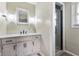 Well-lit bathroom with white cabinets, a sleek mirror, and a modern shower with glass doors at 1891 W 300 N, Anderson, IN 46011