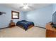 Simple bedroom with light blue walls, carpeted floor, and natural light from window at 1891 W 300 N, Anderson, IN 46011