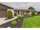 Beautiful landscaping and mature trees highlight this home's inviting curb appeal at 1891 W 300 N, Anderson, IN 46011