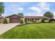 Charming ranch home with a well-manicured lawn and a two car garage at 1891 W 300 N, Anderson, IN 46011