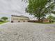 Spacious three-car detached garage with gravel driveway for extra vehicles and storage at 1891 W 300 N, Anderson, IN 46011